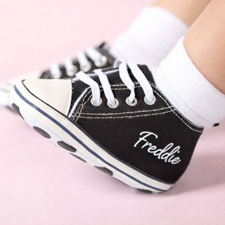 Close-up of personalised baby trainers with name “Freddie”, cute newborn gift idea for boys or baby shower present