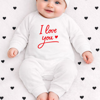 Baby wearing white “I love you” sleepsuit with red text, adorable newborn outfit gift for babies and new parents