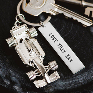 Formula 1 race car keychain with engraved tag reading ‘Love Tilly XXX,’ attached to a set of keys, ideal as a personalised Valentine’s gift