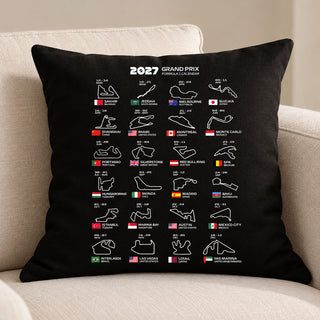 A black square throw pillow featuring a white 2027 Grand Prix Formula 1 calendar print, styled on a beige fabric sofa.