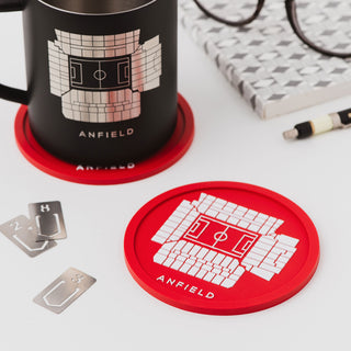 Red Anfield stadium coaster gift  on desk beside black mug with football stadium illustration