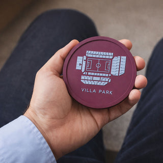 Aston Villa Villa Park stadium coaster held in a man’s hand, showing the claret and blue football stadium design by Iconic Coasters.