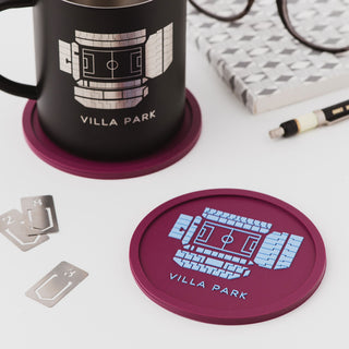 Close-up of an Aston Villa Villa Park stadium coaster showing the detailed football ground design in claret and blue.