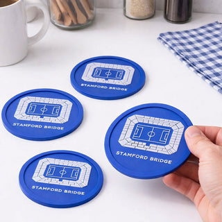 Set of Chelsea FC Stamford Bridge football stadium coasters on a kitchen table, showing flexible blue coasters designed as a gift for football fans.