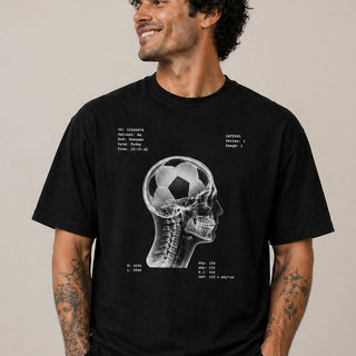Man wearing black football skull x-ray graphic t-shirt in organic cotton, bold design for football fans