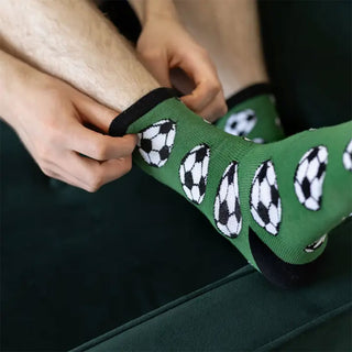 Green football print socks being worn by a football fan
