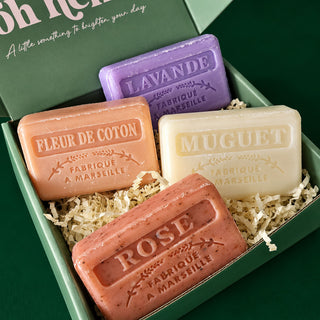four floral french soap bars in a green gift box