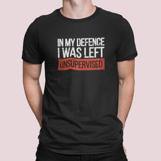 Black t-shirt with the text “In My Defence I Was Left Unsupervised” in white and red distressed lettering, worn by a model