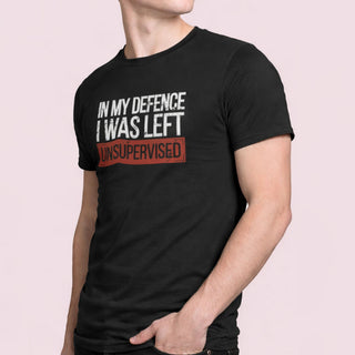 Black t-shirt featuring the phrase “In My Defence I Was Left Unsupervised” in white and red text on the front