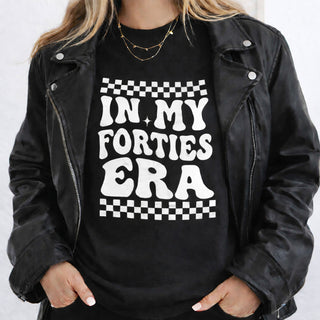 In My Forties Era black t-shirt with solid white print, styled with a leather jacket, organic cotton 40th birthday gift tee