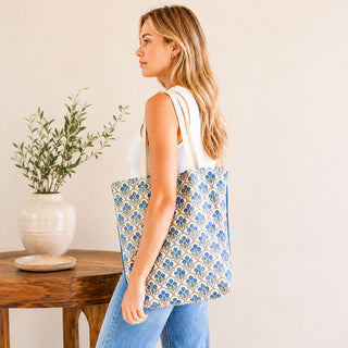 Woman carrying a blue floral block print organic cotton tote bag