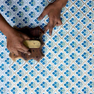 Traditional artisan block printing process creating a blue floral organic cotton tote bag