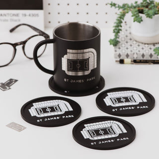 Set of Newcastle United St James’ Park football stadium coasters displayed with a mug on a desk, showing a practical football gift for men.