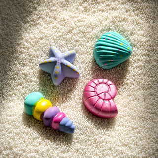 Finished ceramic shells painted in colourful seaside-inspired designs