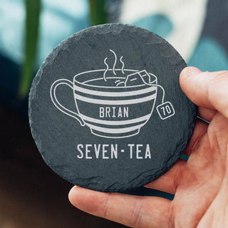 Personalised engraved slate tea coaster for a 70th birthday with teacup design and Seven-Tea milestone birthday pun.