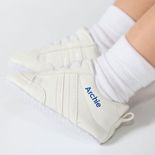 Personalised white baby trainers with name printed in blue, worn on baby feet, suitable for 0–3 months
