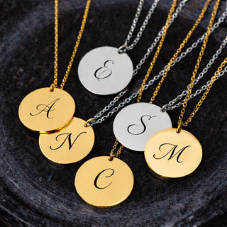 Personalised gold and silver disc necklaces engraved with initials