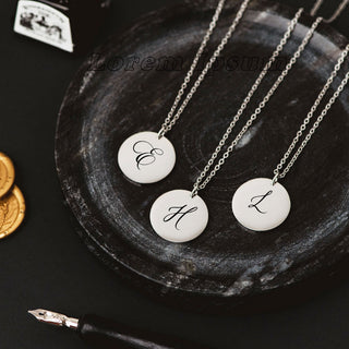 Custom initial disc necklaces in silver with engraved letters