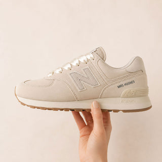 Personalised New Balance 574 wedding trainers customised with a bride's new surname and satin bridal laces