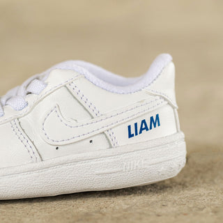 Close up of personalised Nike baby trainers with custom name detail