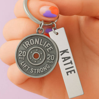 Personalised weight plate keyring with custom engraved name and optional message, gym gift keychain held in hand