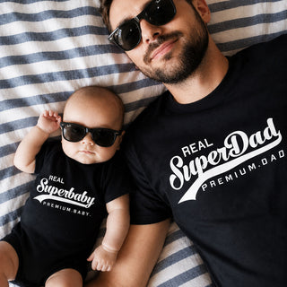 Dad and baby wearing matching Real SuperDad and SuperBaby cotton outfit set hand printed in the UK by Yeah Boo