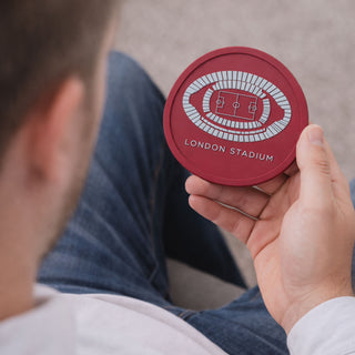 West Ham London Stadium silicone coaster held in a man’s hand, perfect football gift for West Ham fans and stadium memorabilia collectors